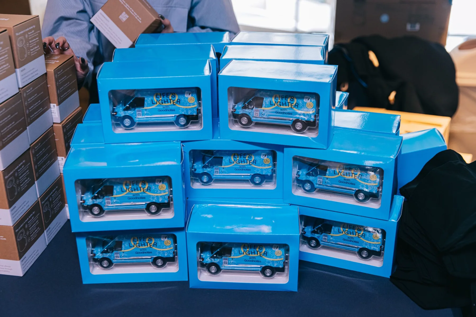 Boxes of miniature Goodnotes van models